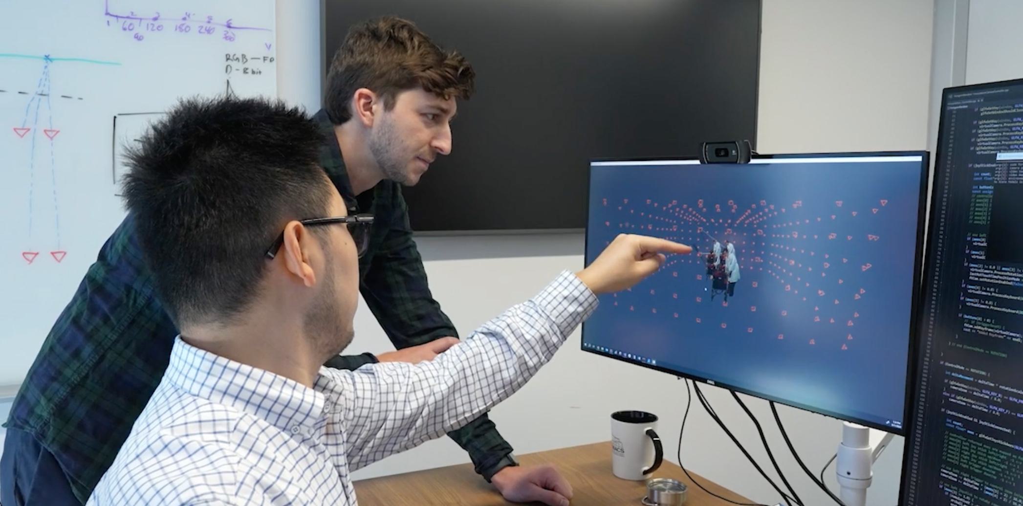 2 people looking at a compouter screen (from UMIACS video) https://player.vimeo.com/video/1032439647?background=1