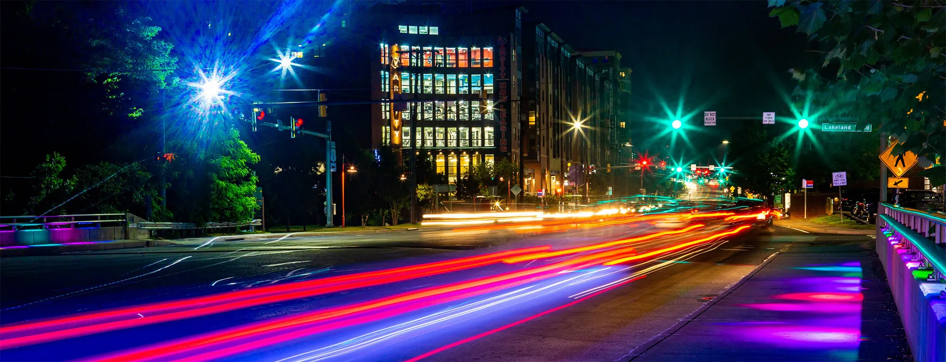 Motion blur of street at night. Buildings in background.