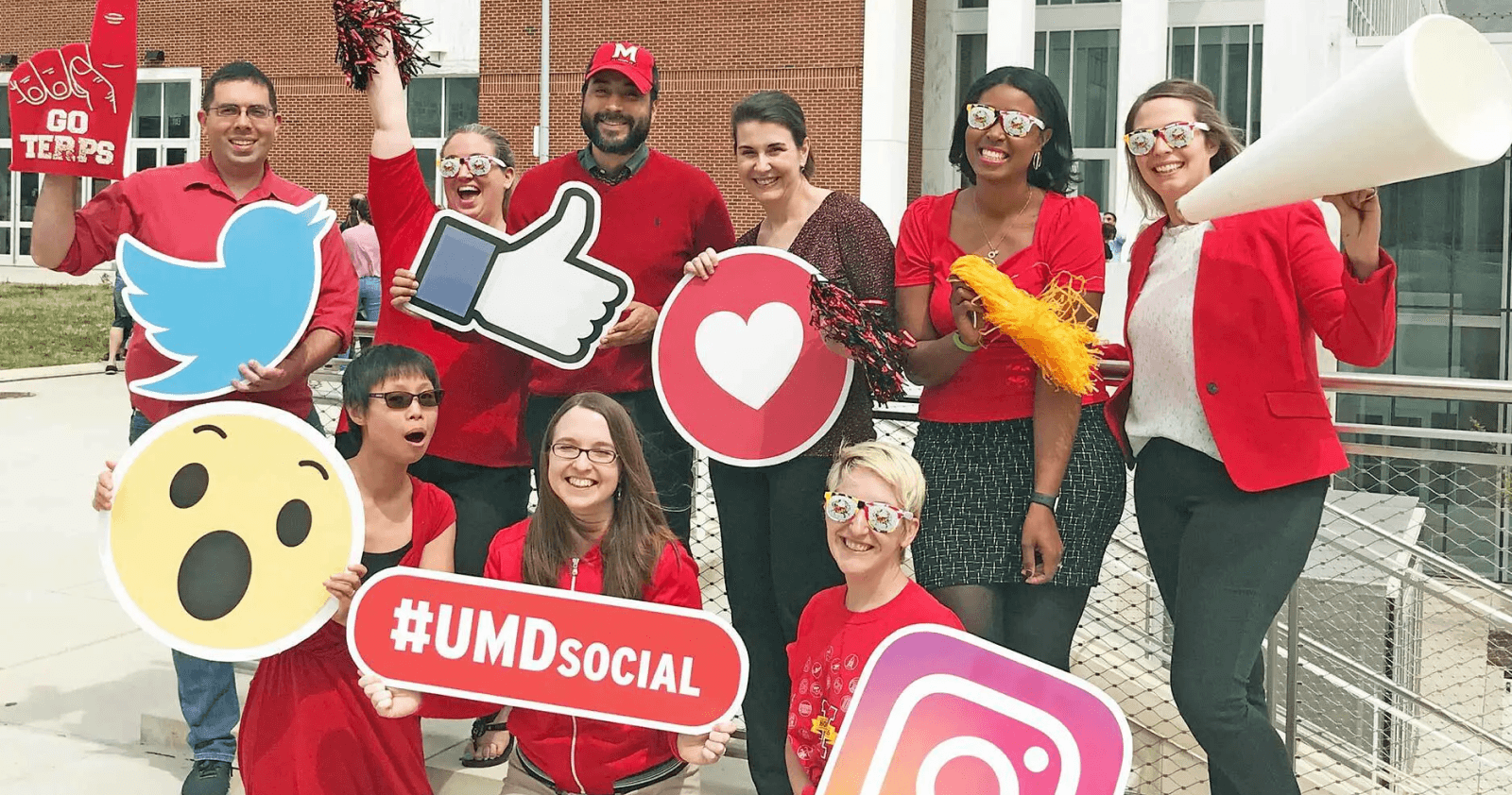 University of Maryland staff cheering with social signs