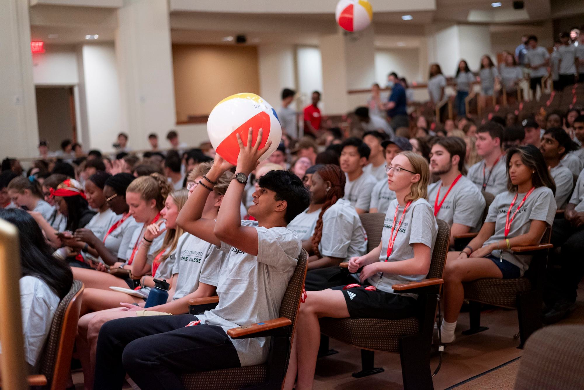 Students play with beach balls at Honors Convocation