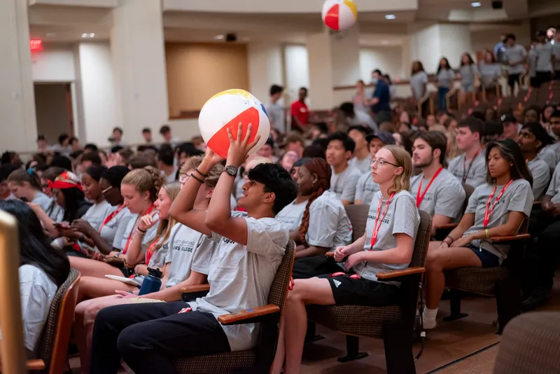 Students play with beach balls at Honors Convocation