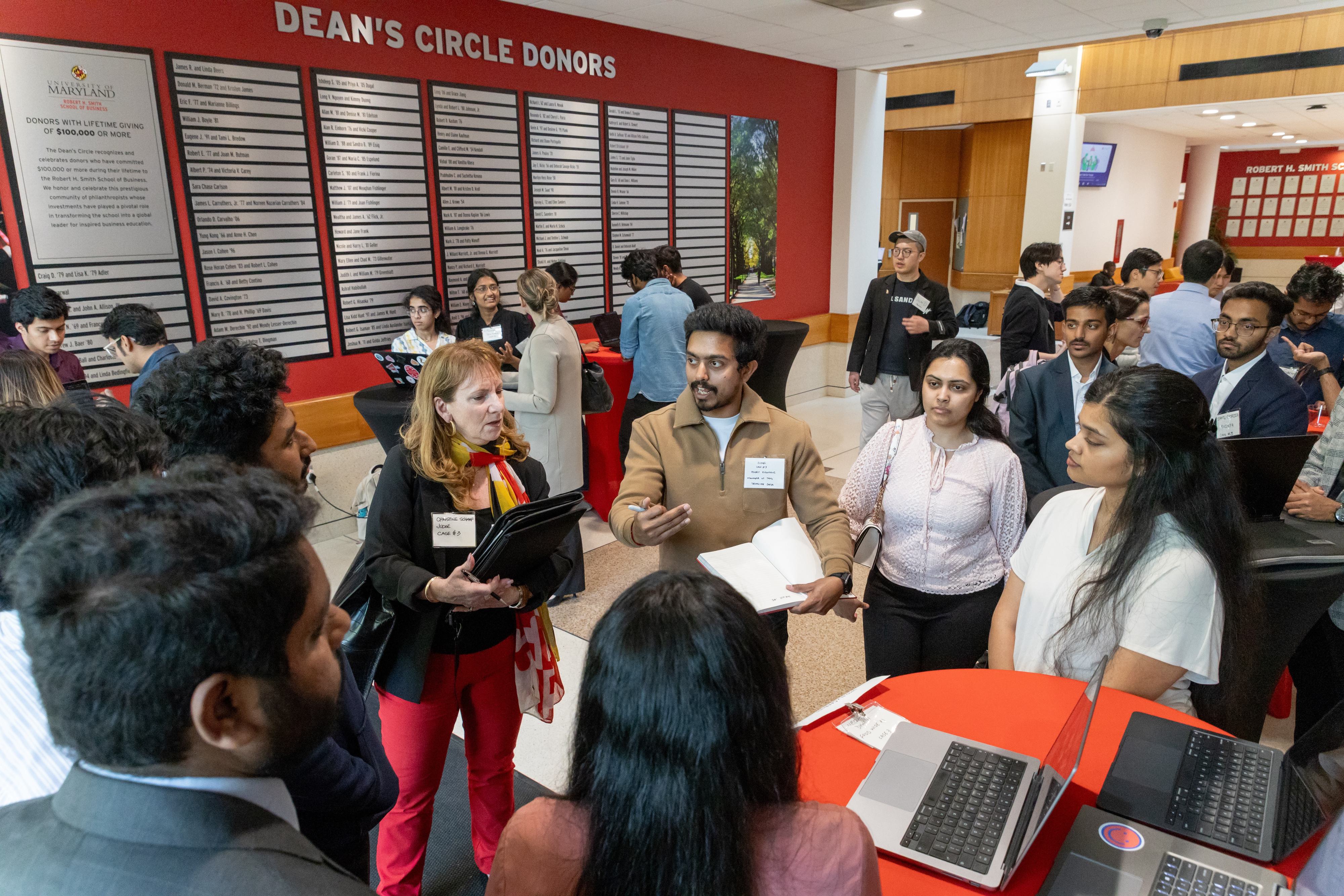A student presents their AI-powered tool to fight food insecurity to case competition visitors and judges