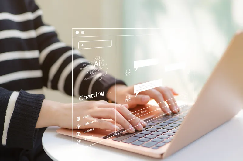 Stock image of someone chatting with an AI chatbot