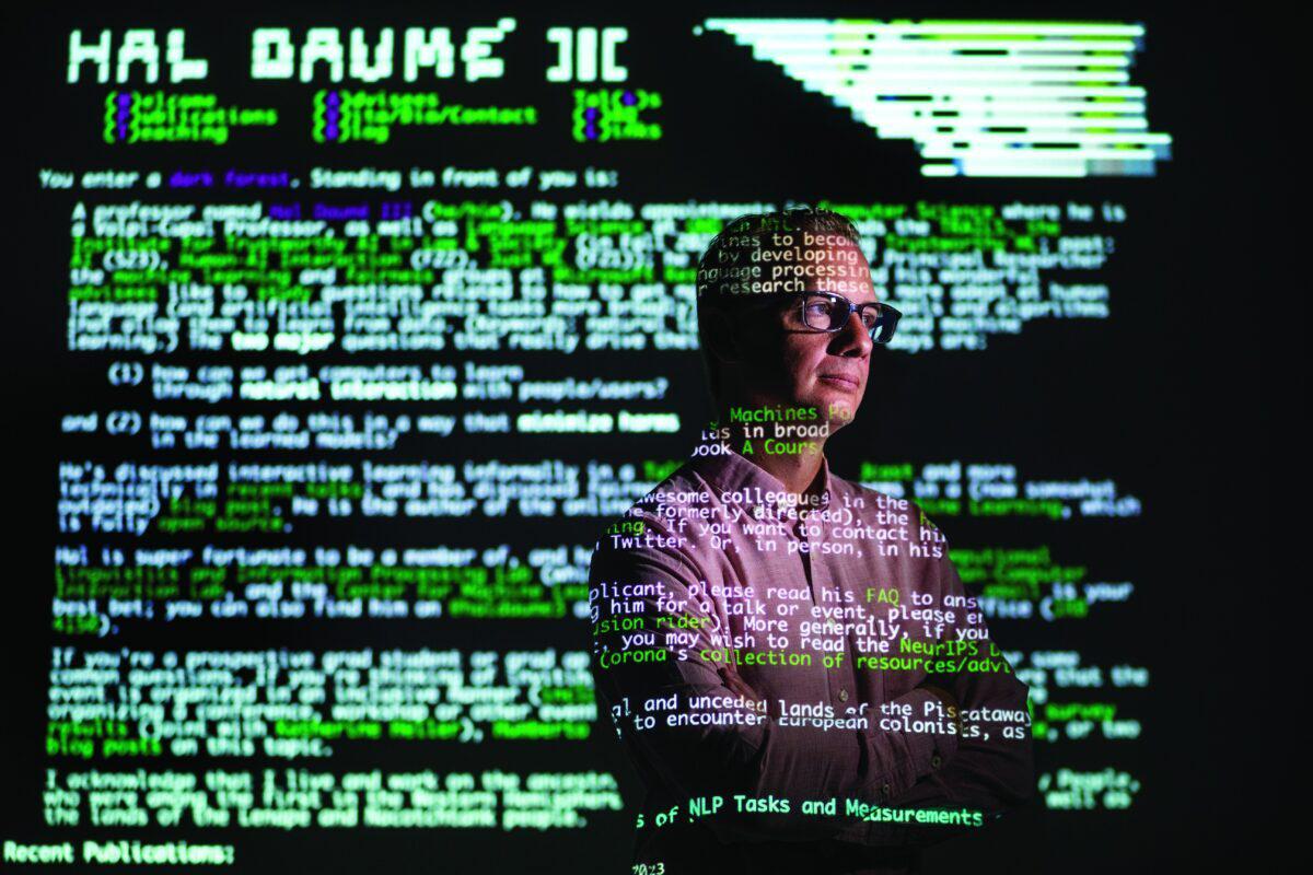 Portrait of a professor standing in front of code projections
