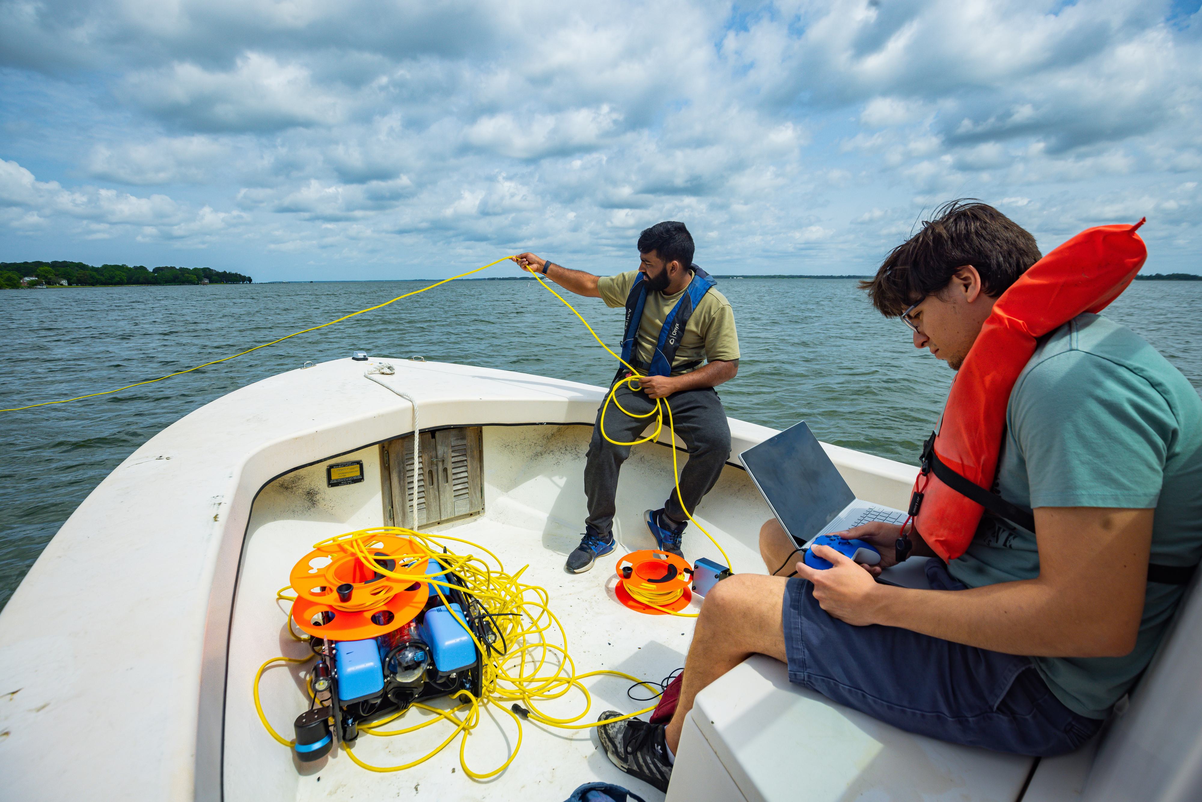 Students control an underwater sensing drone from onboard a boat