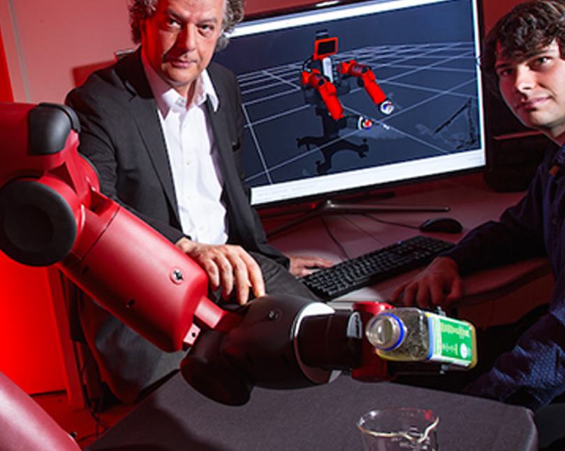 Professor and student working with a robot