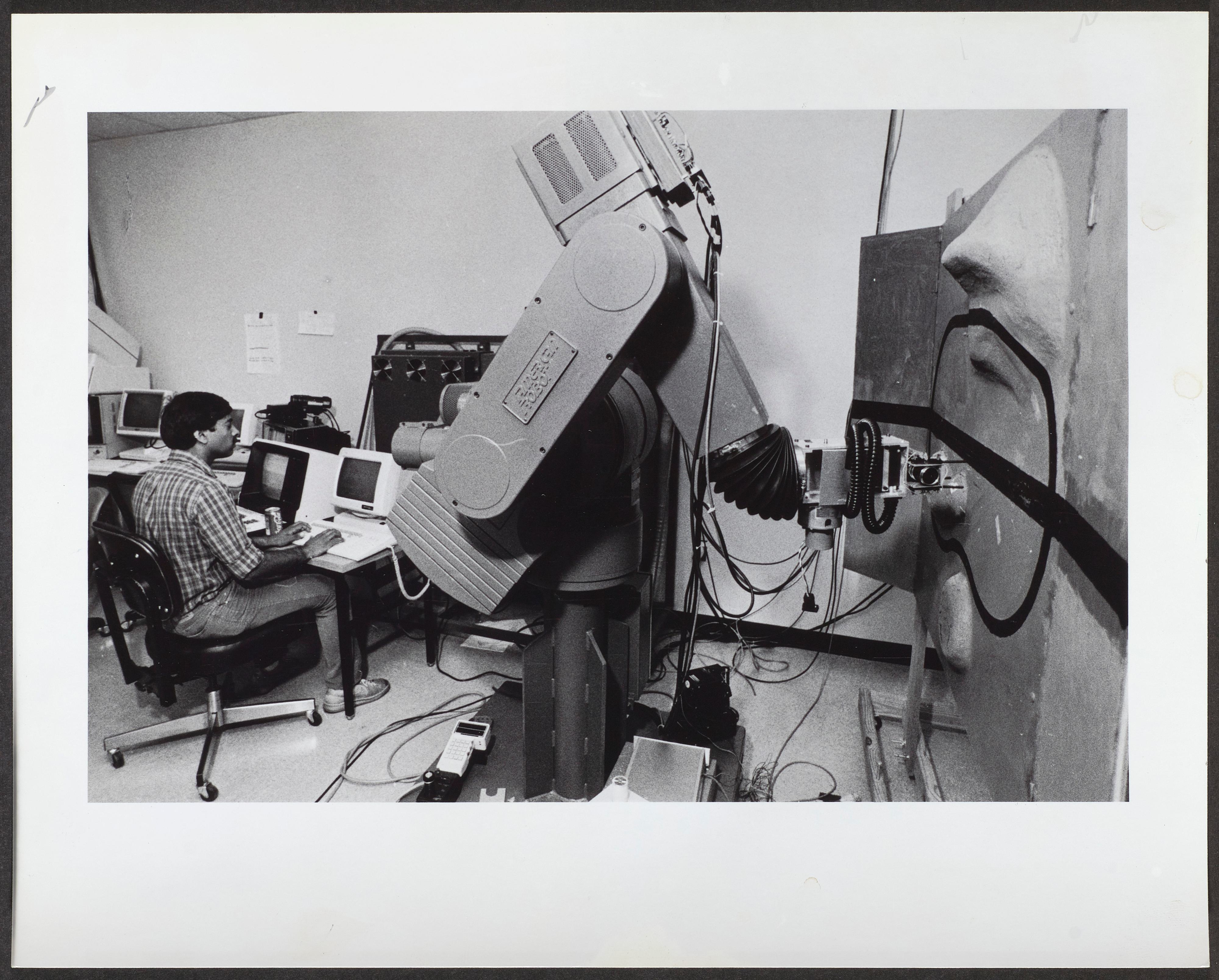 Tharakesh Sitdalingiah, a senior Electrical Engineering major, controls a robotic arm with a nearby computer